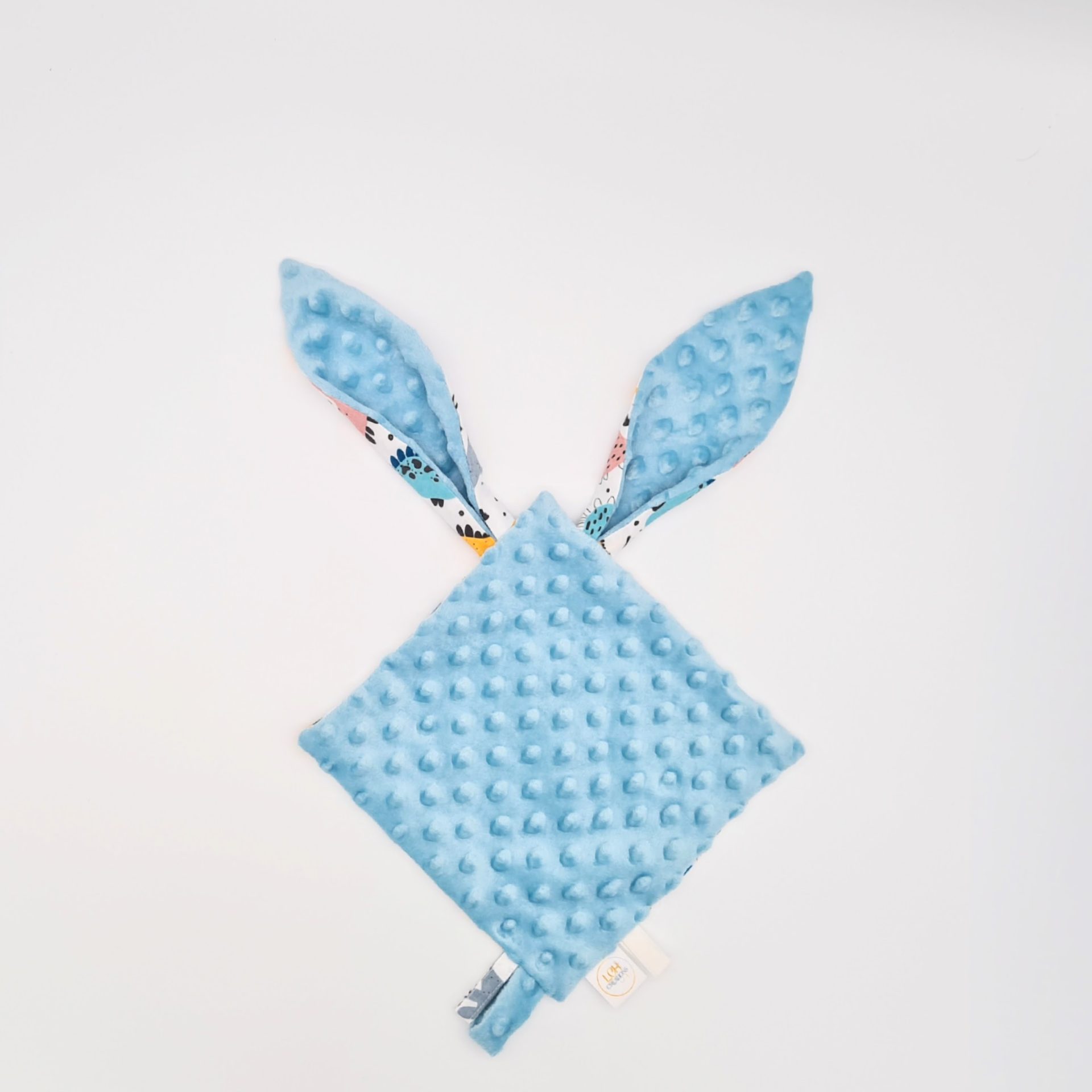 doudou pour bébé à personnaliser avec des motifs de dinosaures colorés